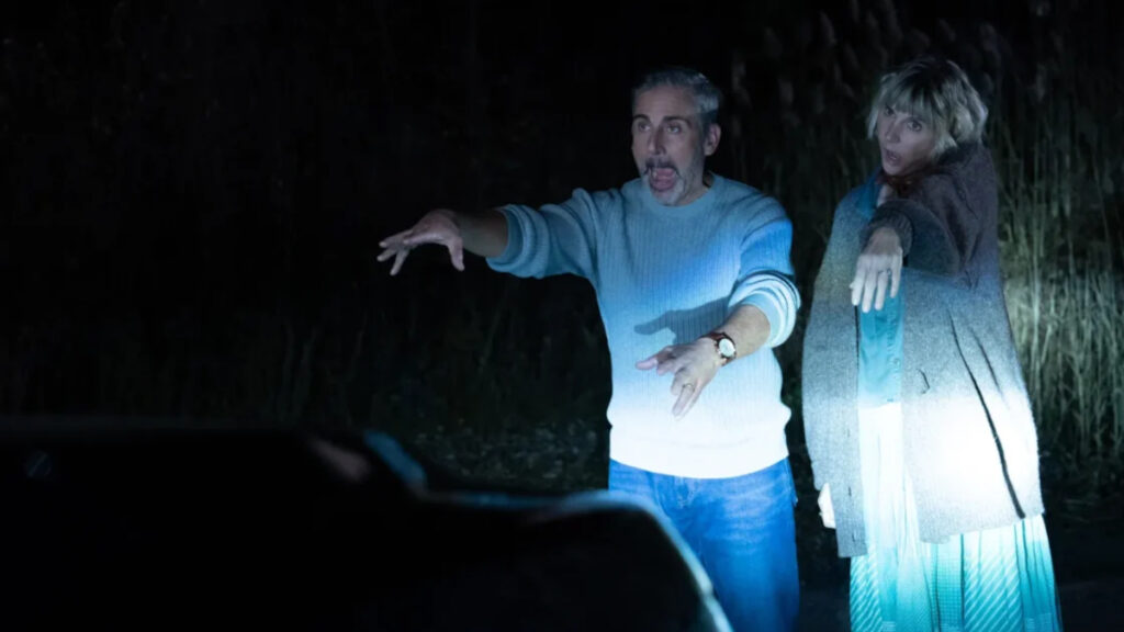 Ein Mann und eine Frau im Scheinwerferlicht eines Autos. Sie bewegen sich wie Zombies.