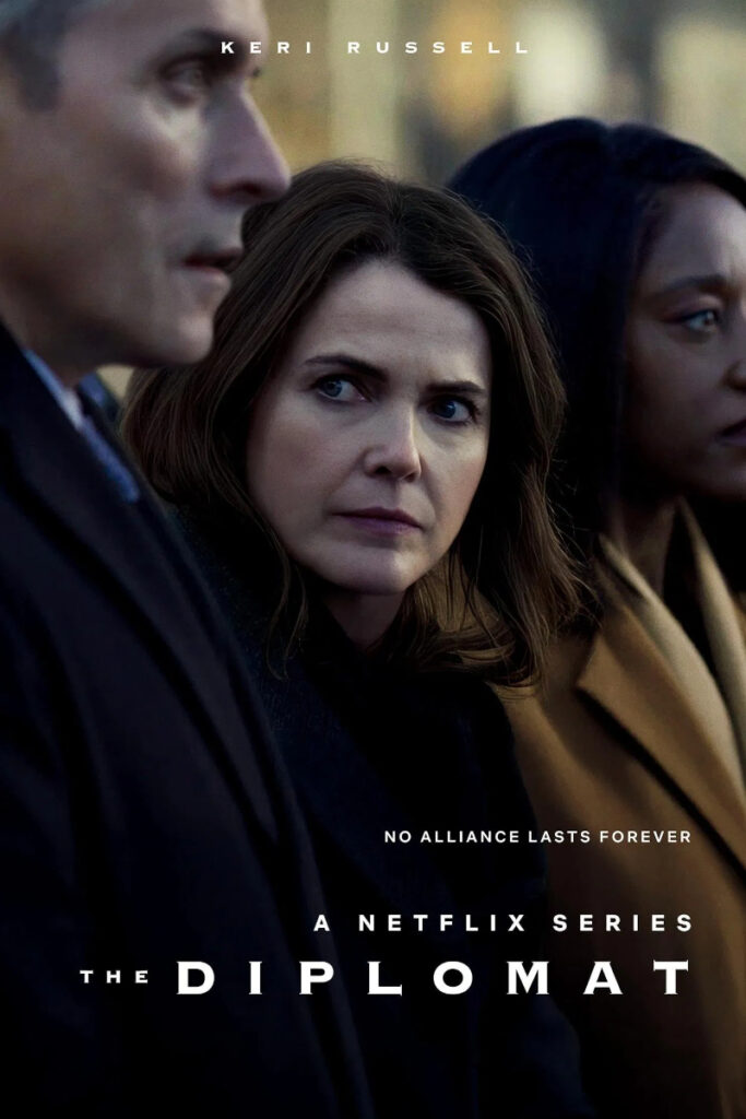 Drei Personen in formeller Kleidung stehen nebeneinander. Die mittlere Person schaut nachdenklich zur Seite. Darüber steht der Name «Keri Russell». Unten ist der Schriftzug «A Netflix Series The Diplomat» zu sehen, begleitet von «No Alliance Lasts Forever». Hintergrund unscharf.