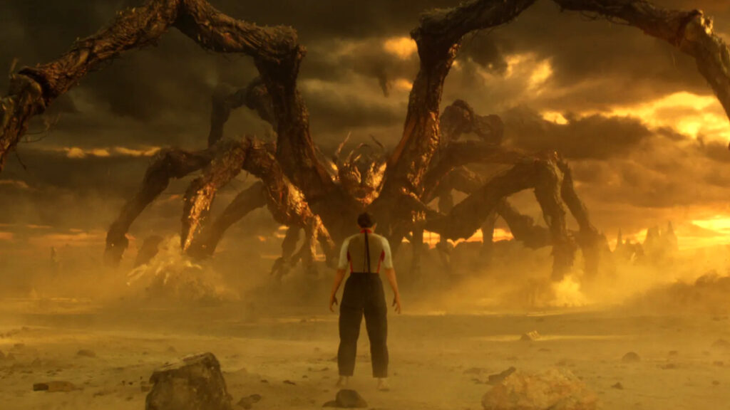 Eine Person steht in einer kargen Wüstenlandschaft, blickt einem riesigen, tentakelartigen Monster entgegen. Der Himmel ist dramatisch in dunklen Tönen gehalten und von schweren Wolken verhangen. Die Szene wirkt bedrohlich und mystisch, unterstrichen durch die düstere Beleuchtung.